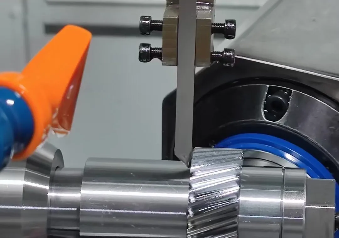 Gear hobbing machine cutting a custom spur gear